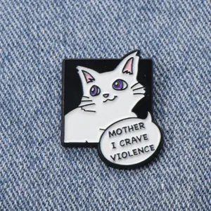 Close-up of a creative cute cat metal enamel pin badge for backpack and clothes decoration.