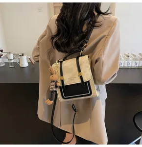 Close-up of retro vintage backpack with rabbit pendant on model