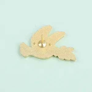 Peace dove brooch back view detail showing secure pin clasp, elegant gold metal accessory.