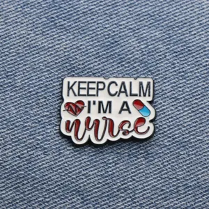 Detailed close-up of nurse theme metal enamel brooch badge with quote, perfect apparel accessory.