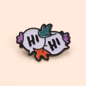 Cute cartoon speech bubble enamel brooch pin with greeting letter design, perfect detail shot.