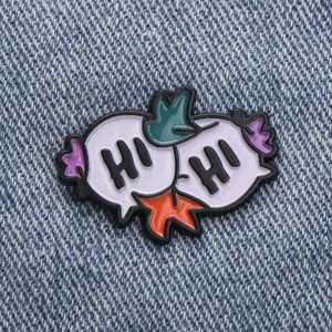 Detail view of a cute cartoon greeting speech bubble enamel pin, stylish denim accessory.