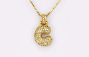 Detail view of gold-plated puffy letter C pendant necklace with sparkling micro-set cubic zirconia.