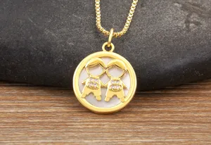 Gold plated double boy pendant necklace featuring mother of pearl and clear cubic zirconia.