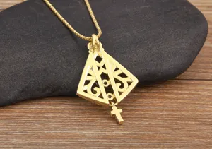 Detailed shot of gold plated hollow geometric pendant necklace with cross charm