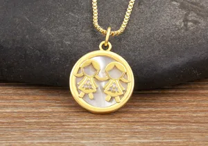 Close-up view of the 18k gold plated mother of pearl double girl pendant necklace detail.