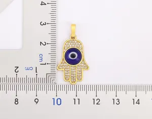Gold plated Hamsa hand evil eye pendant with micro set cubic zirconia for women and girls.