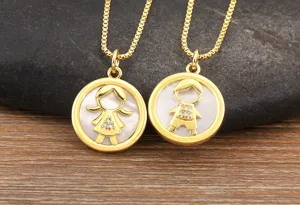 Gold plated mother of pearl boy and girl pendant necklace with sparkling cubic zirconia charms.