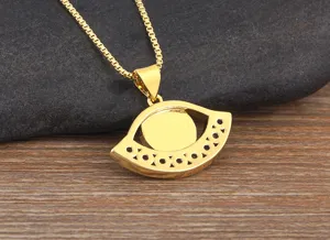 Detailed closeup of copper 18K gold plated evil eye pendant necklace with micro zirconia stones.