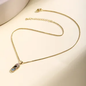 Close-up detail of the gold-plated necklace featuring a cute evil eye shoe pendant and chain.