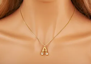 Detailed close-up view of the elegant gold-plated letter A pendant necklace with sparkling zirconia stones.