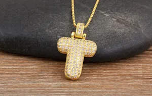 Close-up detail of the gold letter T pendant necklace showcasing brilliant micro-pave zirconia.