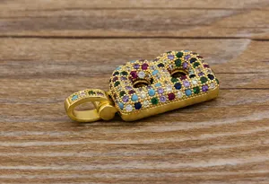 Close-up of a gold-plated initial letter B pendant detailed with colorful cubic zirconia stones.