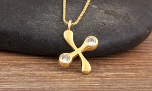 Gold plated copper necklace featuring white zirconia stones, elegant detail view of pendant.