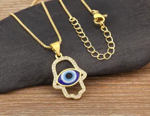 Gold plated Hamsa hand evil eye pendant necklace detailed shot showing zircon stones.