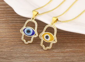 Gold plated Hamsa hand evil eye necklace set featuring sparkling micro-pave cubic zirconia details.