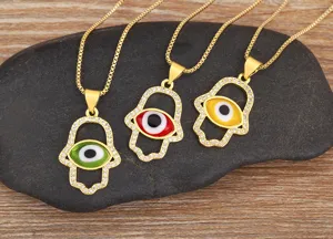 Gold-plated Hamsa hand evil eye pendant necklace with micro-pave cubic zirconia details.