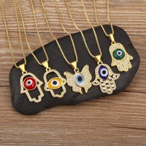 5-piece set of 18k gold plated micro pave cubic zirconia evil eye and hamsa hand necklaces.