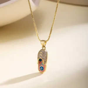 Gold evil eye slipper pendant necklace with sparkling rhinestones for women fashion detail view.
