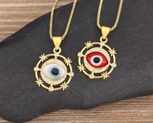 Detail view of gold evil eye pendant necklaces with micro-inlaid zirconia on dark stone.