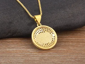 Detailed shot of gold-plated hollow geometric evil eye pendant necklace with micro zircon.