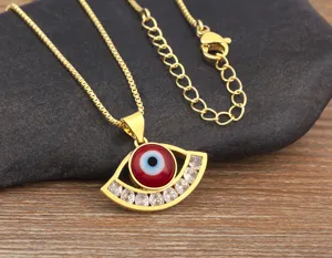 Gold-plated evil eye necklace with red enamel and sparkling cubic zirconia stones.