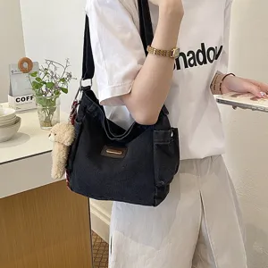 Casual black canvas shoulder bag for women, large capacity daily commuter crossbody handbag.
