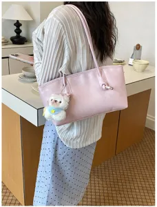 Pink leather shoulder tote bag for women, large capacity minimalist handbag with cute bear charm.
