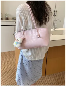 Pink shoulder tote bag for women, minimalist daily commuter handbag with cute plush pendant.