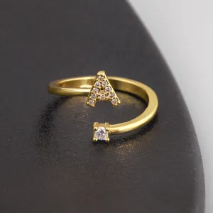 Close-up detail of the gold-plated initial A ring featuring sparkling micro-pave zirconia stones.