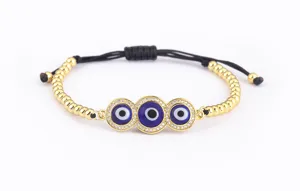 Bracelet oeil malefique triple exquis orne de zircone micro-serti et cordon noir reglable.