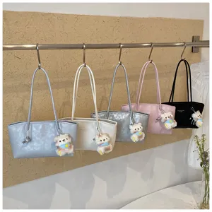 Detailed view of stylish minimalist tote shoulder bags with cute bear plush charms in colors.