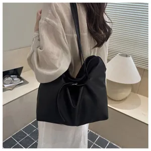 Slouchy black leather tote bag, minimalist shoulder bag for everyday chic fashion.