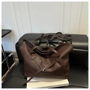 Stylish slouchy brown leather tote bag for women, minimalist casual shoulder handbag.