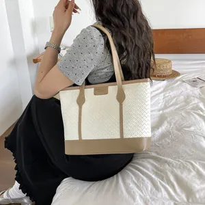 Large woven tote bag for women, stylish commuter shoulder bag with contrast color design.