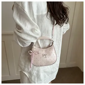 Pink polka dot crescent shoulder bag detail view, sweet style daily fashion accessory.