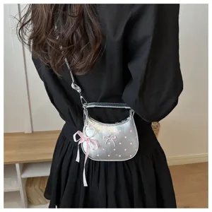 Silver crescent shoulder bag featuring pink polka dots and cute bow charm details.