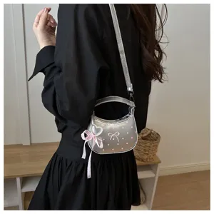Silver crescent crossbody bag with pink polka dots and cute bow charm for women daily fashion.