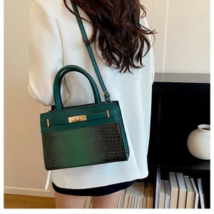 Detail view of green top handle shoulder bag, trendy crossbody commuting square bag for women.