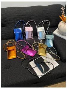 Fashionable patent leather vertical mini crossbody phone bag for women with chic metallic finish.