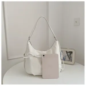 White slouchy shoulder bag detail, elegant hobo bag with cute bowknot design accent.