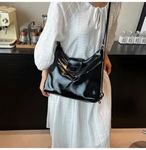 Black glossy PU leather crossbody shoulder bag with flap closure and slim strap for women.