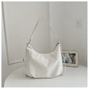 Detailed view of white hobo shoulder bag, soft leather material with zipper closure.