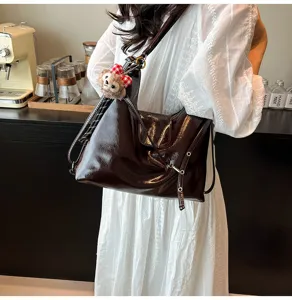 Vintage commuter tote bag for women, large capacity shiny leather shoulder bag, stylish design.