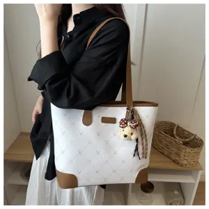 Elegant white tote bag for women with stylish monogram pattern and cute puppy charm.