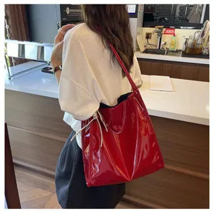 Stylish red patent leather shoulder tote bag for women, large capacity casual daily commuter use.