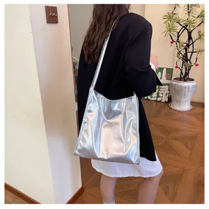 Silver metallic shoulder tote bag detail view showing spacious interior and glossy texture.