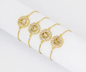 Close-up detail of adjustable gold plated letter bracelets featuring sparkling zirconia.