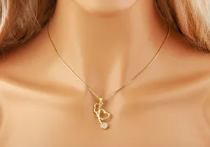 Detailed shot of gold stethoscope heart pendant necklace showing delicate rhinestone details.