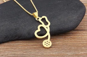 Gold plated stethoscope heart pendant necklace detail, medical jewelry gift close up view